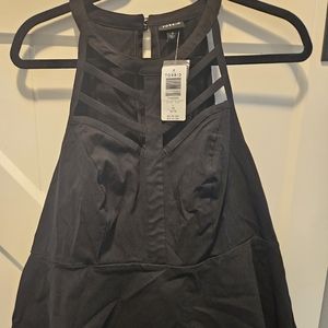 Torrid black sleeveless top w/strap detail front. Great for a night out!